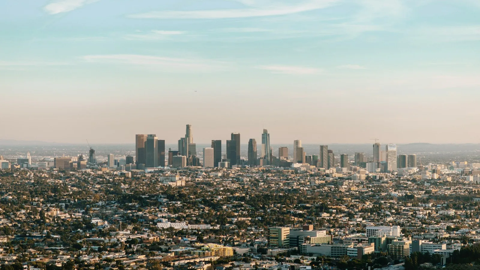 Downtown city skyline with glass towers beneath a clear blue sky